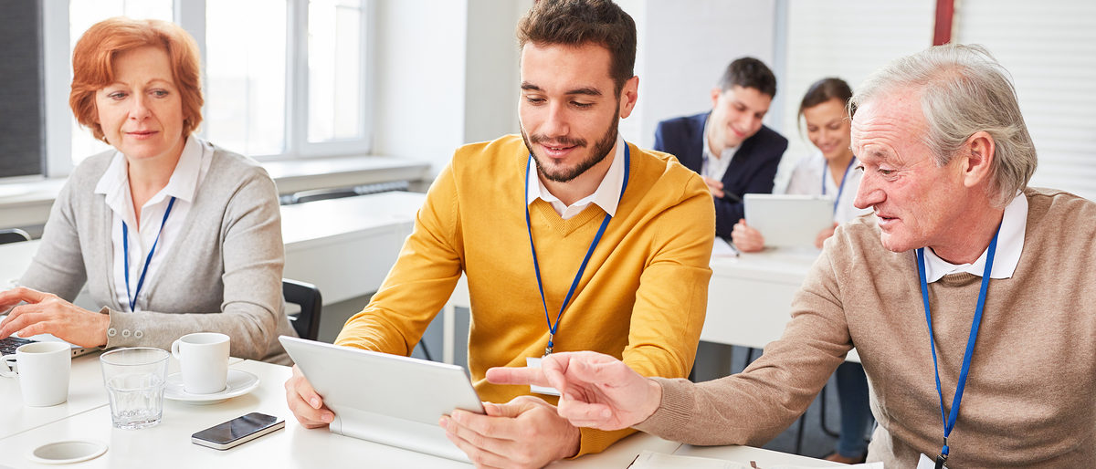 Senior in einer Schulung im EDV Seminar hilft einem jungen Kollegen am Tablet PC Senior in einer Schulung im EDV Seminar hilft einem jungen Kollegen am Tablet PC Schlagwort(e): EDV, Schulung, Seminar, Teamarbeit, Hilfe, helfen, Senioren, Business, Team, zusammen, Fortbildung, Weiterbildung, Workshop, E-Learning, lernen, Internet, online, Computer, PC, Tablet, Technologie, wireless, Gruppe, Leute, arbeiten, Tisch, Konferenzraum, Kommunikation, Mitarbeiter, Beruf, Gesch¿ftsleute, Arbeit, Mann, Frau, Gesch¿ftsfrau, Gesch¿ftsmann, Unternehmen, Kollegen