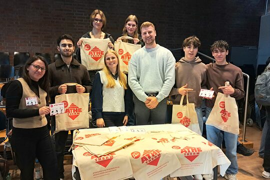 Acht Personen präsentieren die Werbesticker.